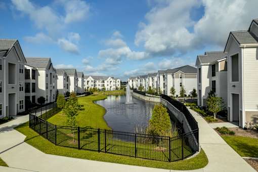 A row of houses with a pond in the middle.