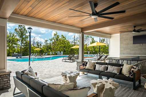 A modern outdoor living space with a pool and lounge chairs.