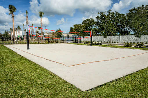 A tennis court with a red net and white lines.