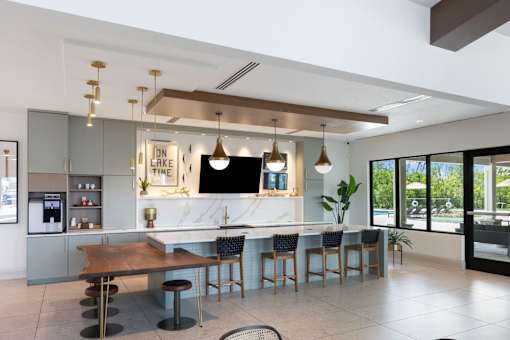 A modern kitchen with a bar area and a dining table.