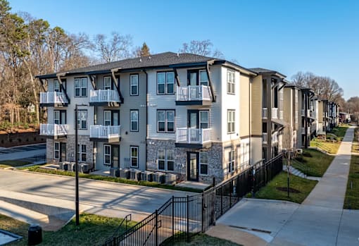 Apartment complex with a black fence in front.