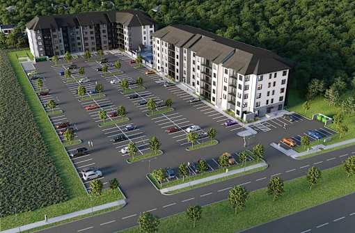 A parking lot in front of apartment buildings.