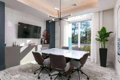 A conference room with a large table and chairs.