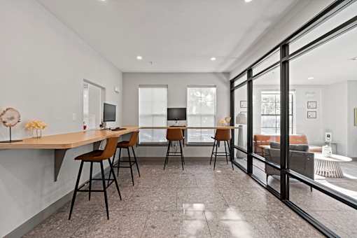A modern dining room with a glass door leading to a balcony.