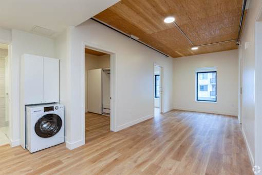 A room with a washing machine and a window.