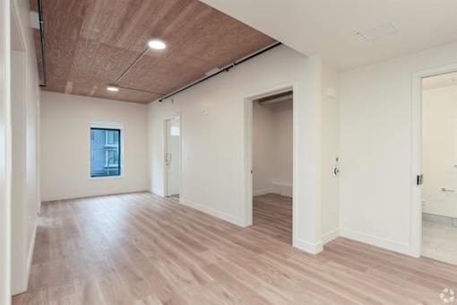 A room with wooden floors and white walls.