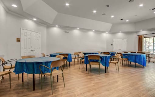 A room with tables and chairs set up for an event.