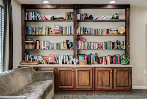 A bookshelf filled with books of various sizes and colors.