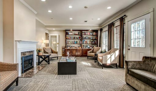 A living room with a fireplace, a bookshelf, and a couch.