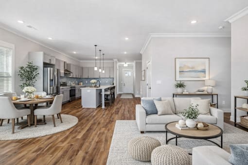 A modern living room with a dining table and chairs.