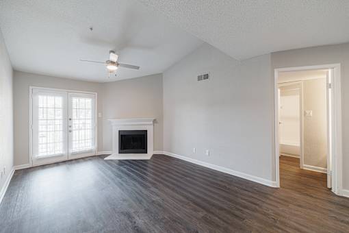 A spacious living room with a fireplace and sliding glass doors.