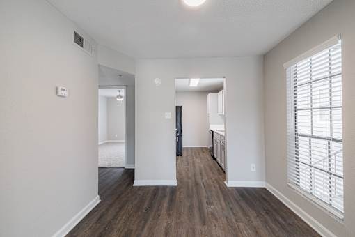 A room with wooden floors and white walls.