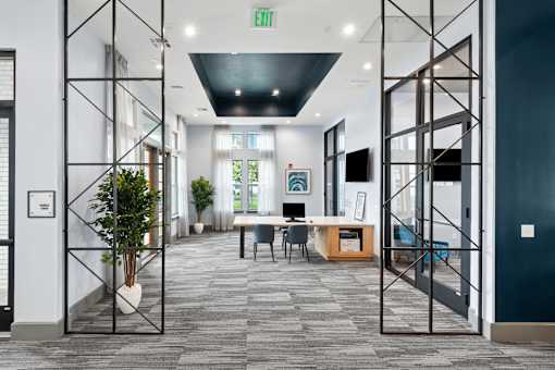 A hallway with a green exit sign above the door.