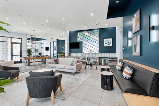 A modern living room with a grey sofa and a wooden coffee table.