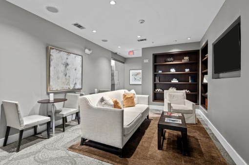 a living room with a couch and chairs and a television