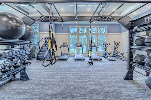 A gym with a variety of equipment including weights and exercise machines.