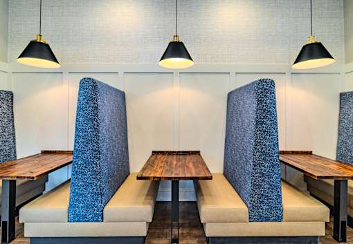 A restaurant with blue chairs and tables.