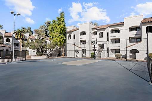 A large white building with a courtyard in front.