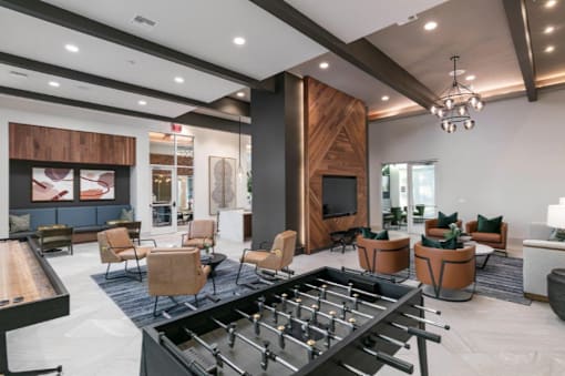 A foosball table is in the middle of a modern living room.