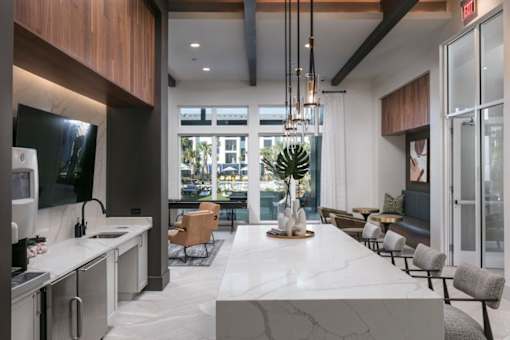A modern kitchen with a marble countertop and a large island.