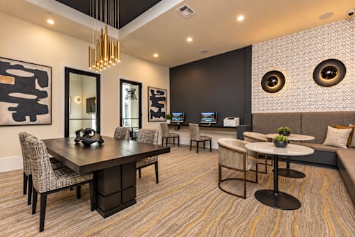 A modern dining room with a large table and chairs.