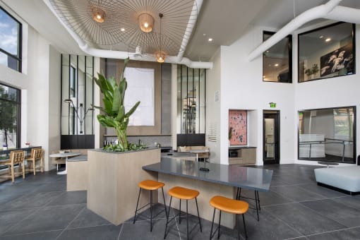 a lobby with a table and four stools