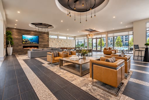 A modern living room with a large television and comfortable seating.