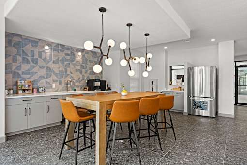 A modern kitchen with a dining table and chairs.