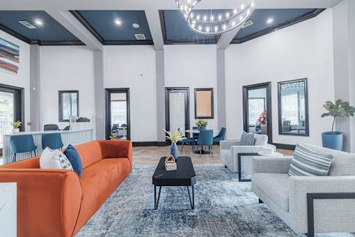 A modern living room with a large orange sofa and a black coffee table.