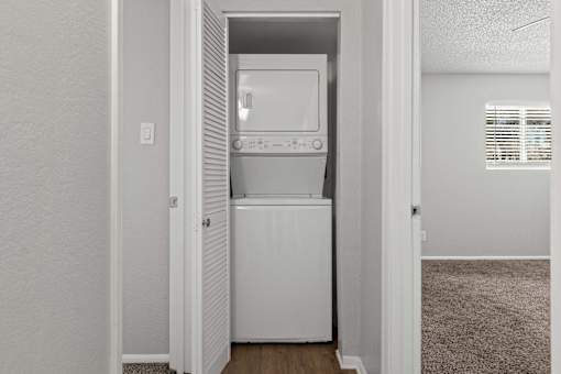 A white dishwasher is built into a kitchen cabinet.