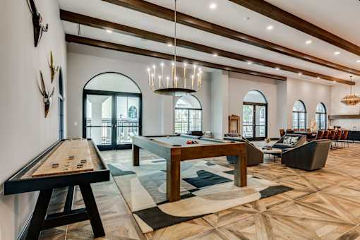 A billiard table is in the middle of a room with a pool table.