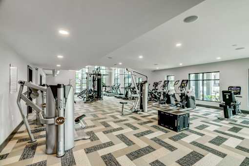 A spacious gym with a variety of equipment.