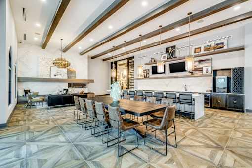 A modern kitchen with a dining table and chairs.