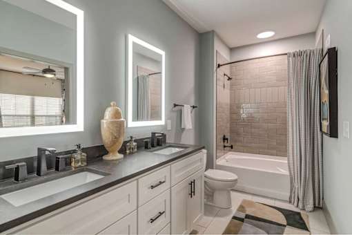 A bathroom with a white toilet, a sink, and a bathtub.