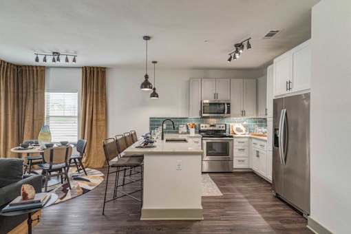 A modern kitchen with a dining table and chairs.