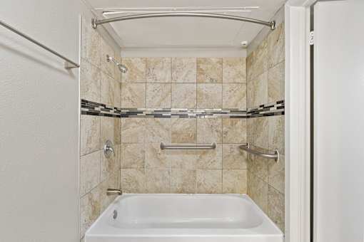 A white bathroom with a tub and a shower.