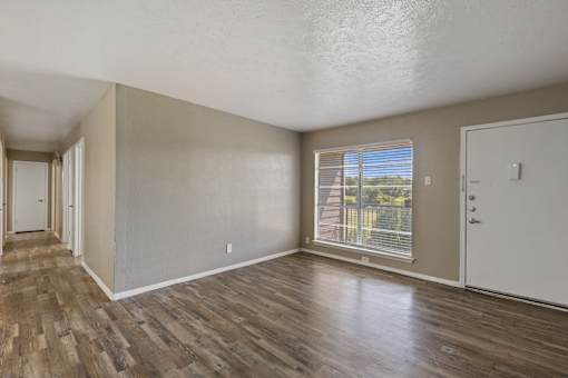 A room with wooden floors and white walls.
