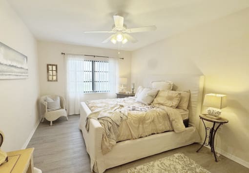 a bedroom with a bed and a ceiling fan
