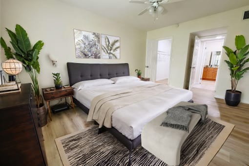 a bedroom with a large bed and a rug