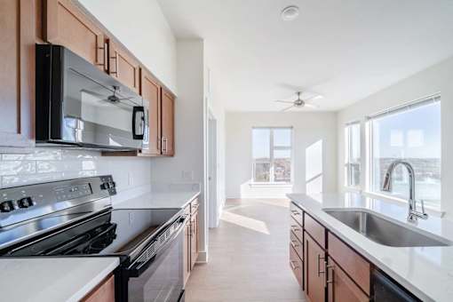 A modern kitchen with a stove top oven and microwave.