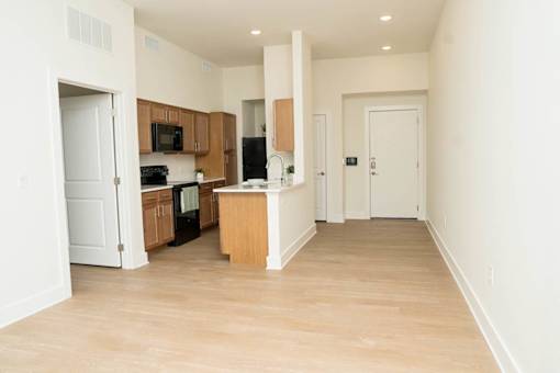 A kitchen with wooden floors and white walls.
