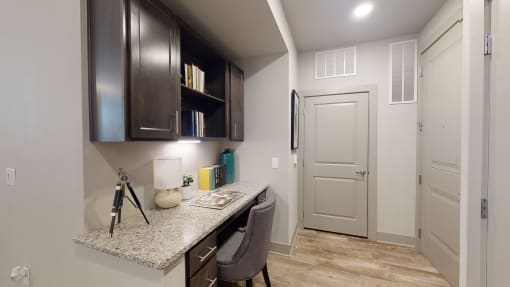 a home office with a desk and cabinets