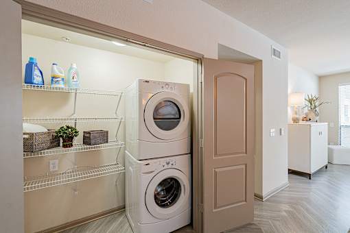A white washing machine is in a laundry room.
