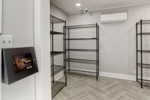 a walk in closet with shelving and a television