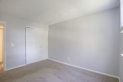 a bedroom with grey walls and a white door