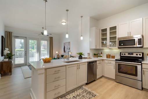 A modern kitchen with a large island and stainless steel appliances.