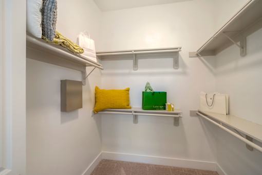 A small room with a shelf and a green bag on it.