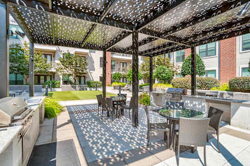 A patio with a table and chairs under a canopy.