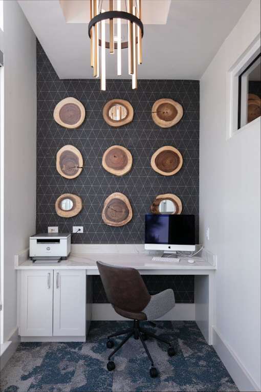 A white desk with a computer monitor and a printer on it.