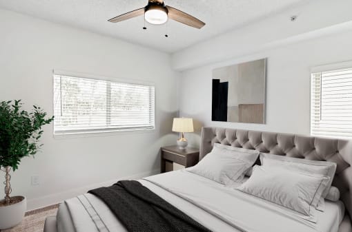 a bedroom with a large bed and a ceiling fan